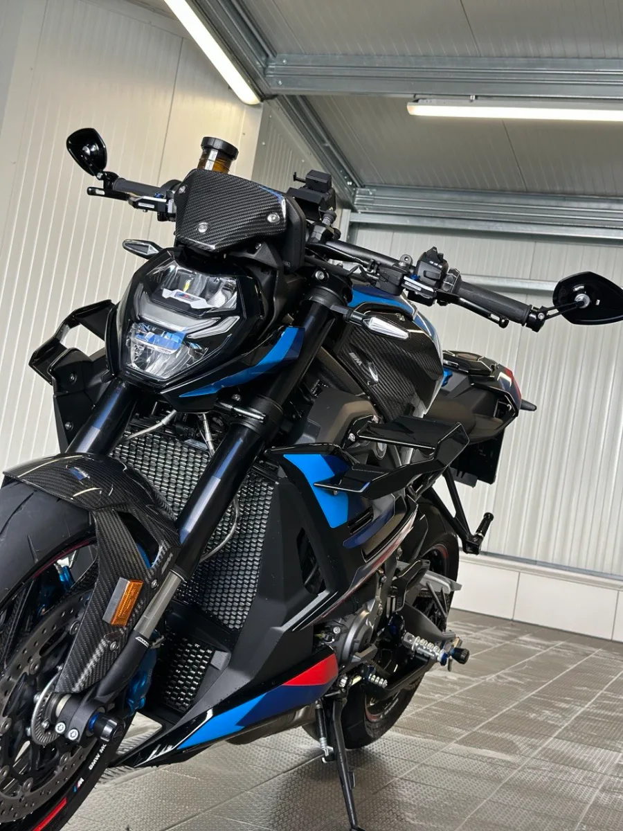 Detailaufnahme einer BMW M1000R — Carbon, Aluminium und lackierte Teile zeigen die vielen Materialien einer Motorradaufbereitung